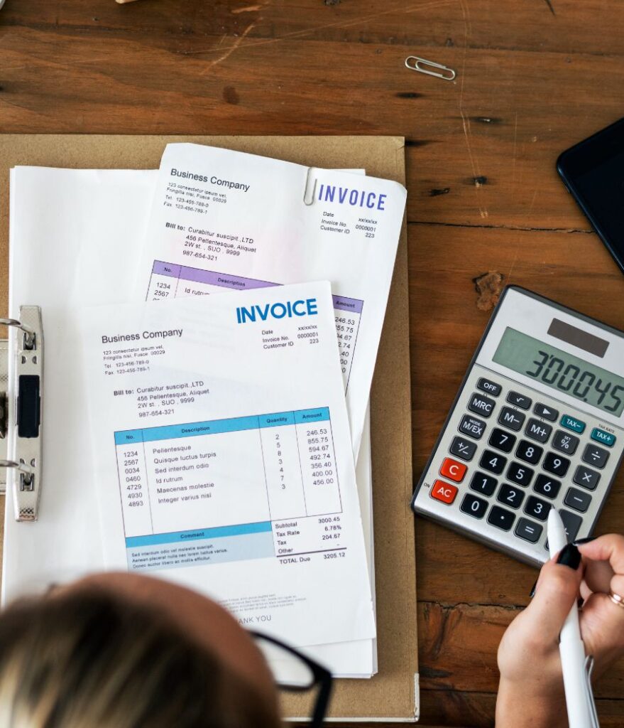 woman going through a stack of invoices.