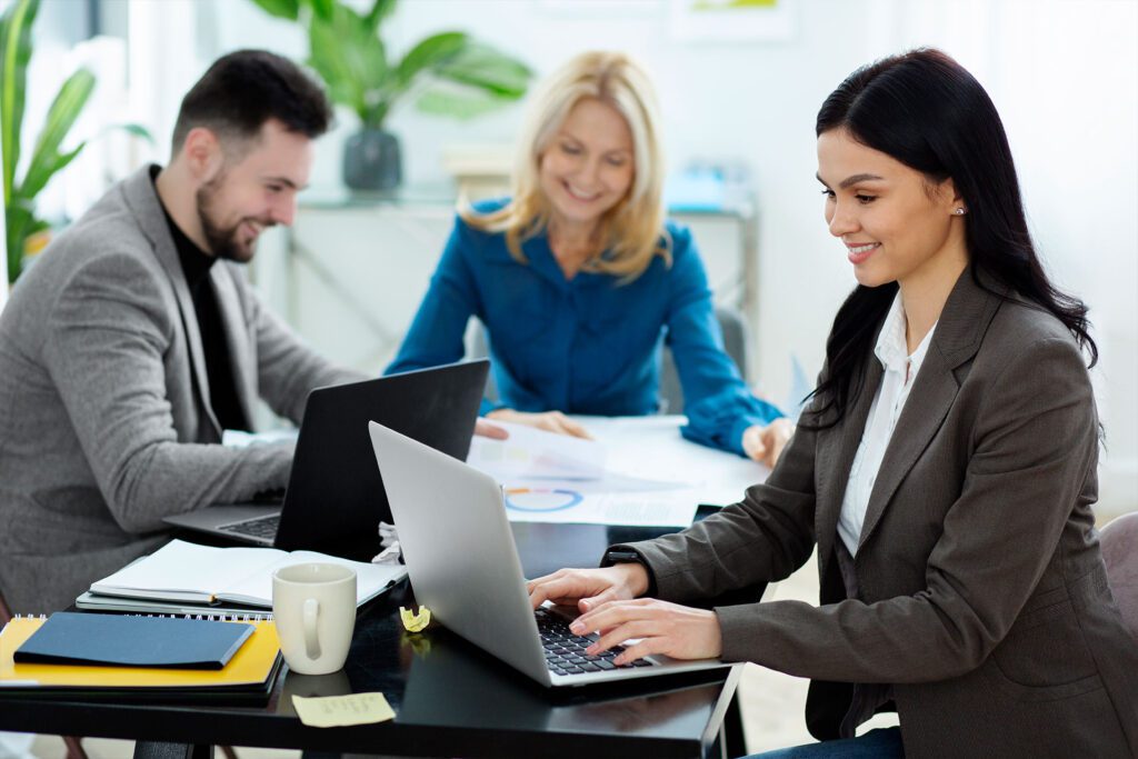 An office workers diligently sorting through piles of paperwork at a desk